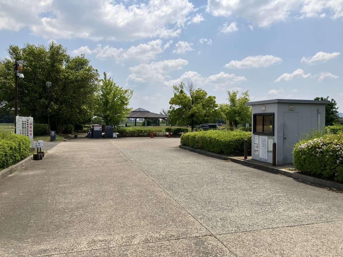 The parking lot entrance on the left — keep going straight